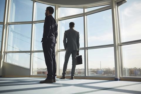 Men standing in office looking out of the window