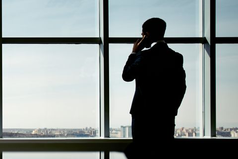 Businessman enjoying window view talking on the phone