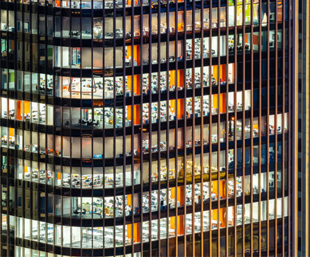 Late working urban concept window facade business center office skyscraper night
