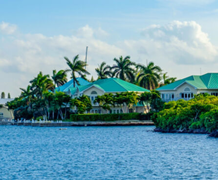 Houses by the Caribbean Sea in the residential area of Governors Creek in Grand Cayman, Cayman Islands