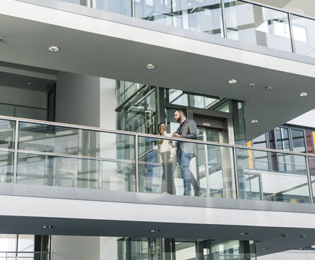 Business people talking outside of office floor