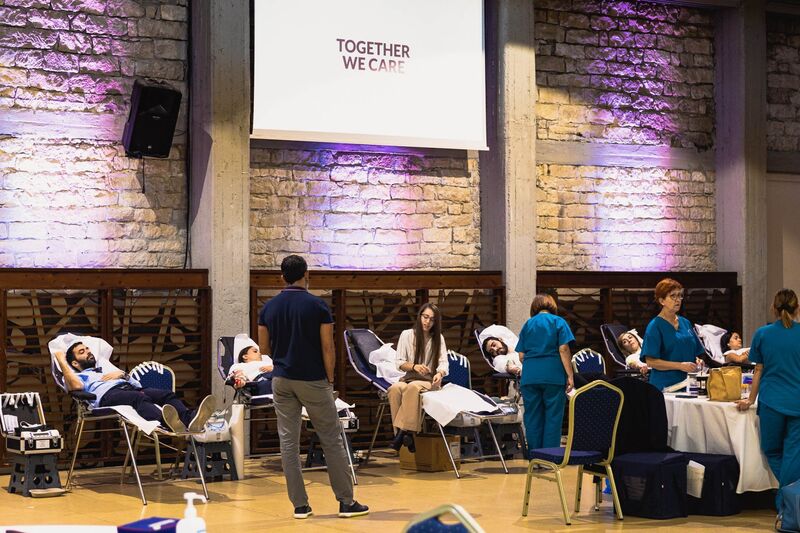 Blood donors laying on bed giving blood
